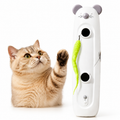 Orange cat reaching toward a white electronic mouse toy with green feather tail