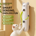 White cat playing with wall-mounted smart mouse toy with green feather tails